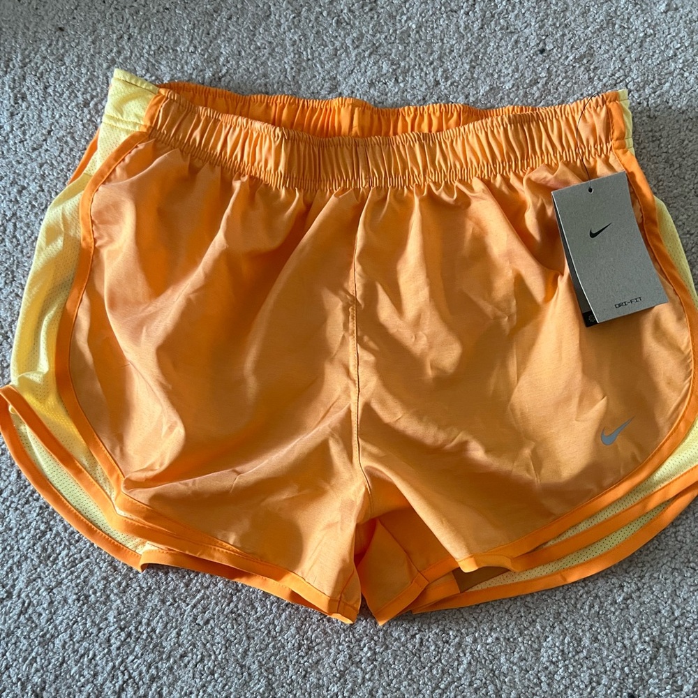 Nike orange Dri-Fit shorts.